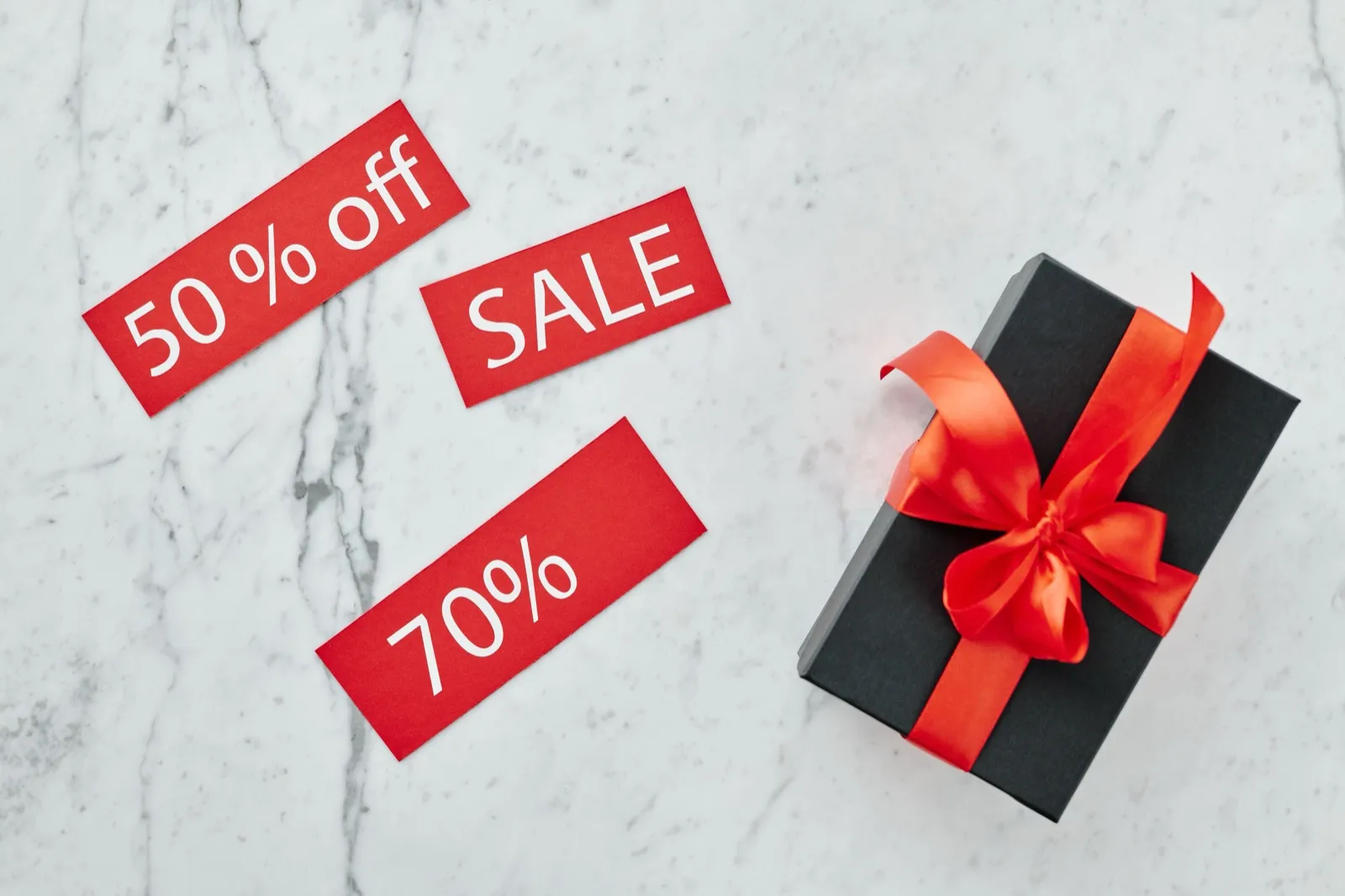 A gift box with discount tags, representing streaming gift cards bought with crypto